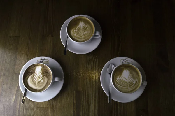 Three cups ready to be served coffee with milk — Stock Photo, Image