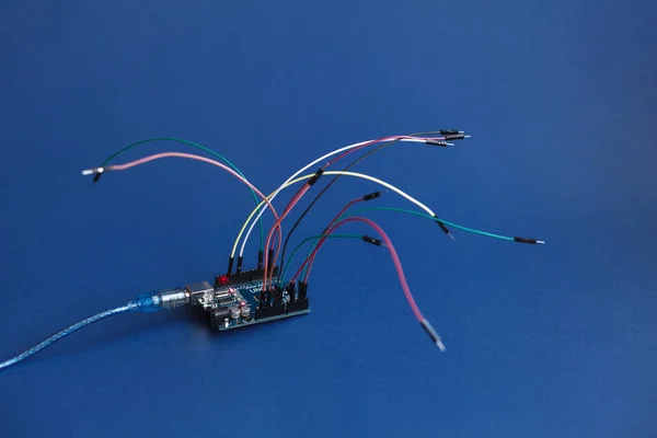 TERNOPIL, UKRAINE - May 5, 2019: Arduino Uno board micro controller for the development of simple automation systems and robotics, microcircuit, wires for building digital devices, interactive objects