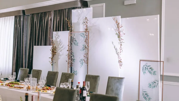 Wedding table serving. Wedding classic decor. Wedding decorated table for the newlyweds. Beautiful decor with pastel roses and greenery