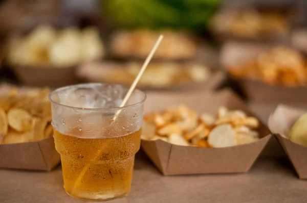 Cool drink of cider, beer, lemonade, in a glass on wooden rustic snacks background. Alcoholic drink concept.  lose-up, space for text, soft selective focus