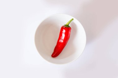 tüm yuvarlak kase ile beyaz zemin üzerine kırmızı biber