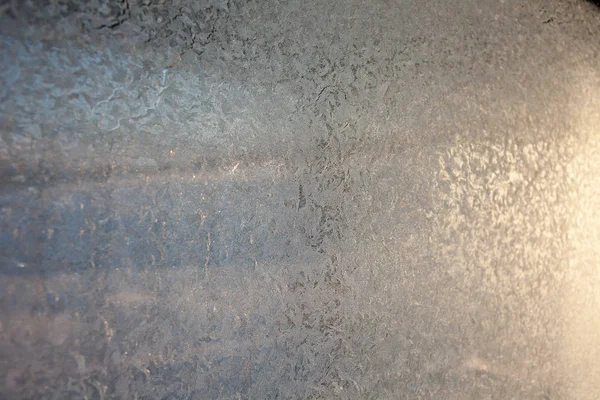 Ornate frost pattern on frosted window as Christmas background
