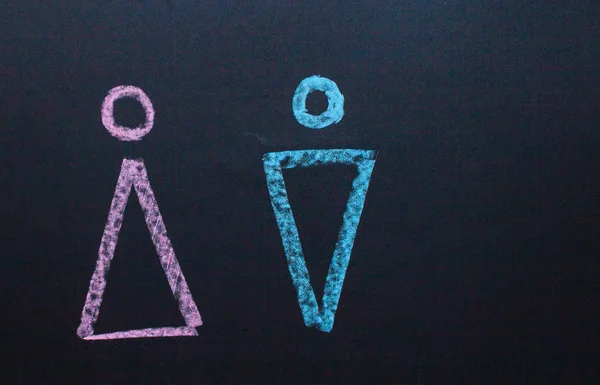 The female gender symbol is equal to the male concept of gender equality. Drawing with chalk on the chalk Board
