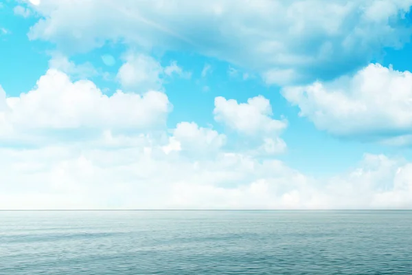 Blue sea and sky with clouds. Concept of world ocean day and conservation of the environment. Copy space.