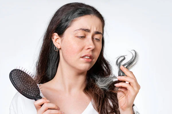 Eine Betrübte Brünette Frau Hält Einen Kamm Mit Herausfallenden Haaren — Stockfoto