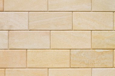 Yinelenen tuğlalardan oluşan Marmoreal taş duvar. Bej rengi.