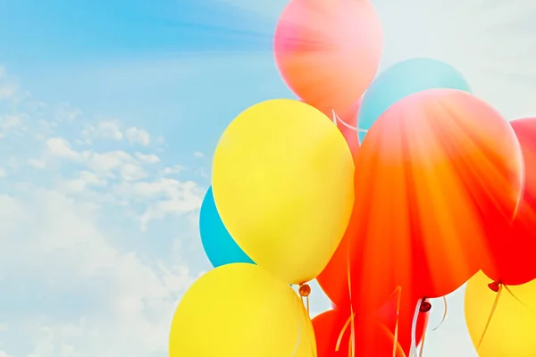 Colorful balloons in the sun against the blue sky.with copy space.