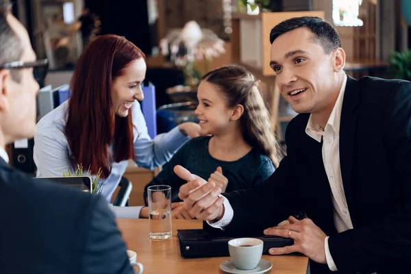 Family sitting in office of lawyer and solving their problems