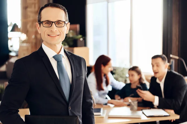 Confident adult man in suit standing in front of office of family lawyer