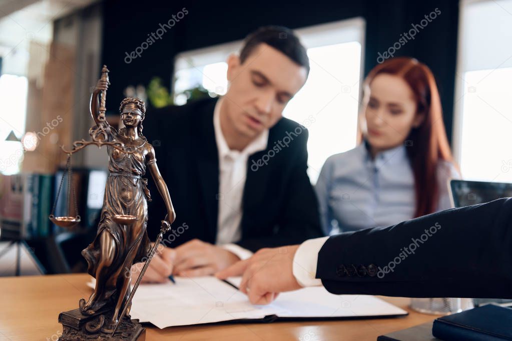 man signing documents at lawyer office