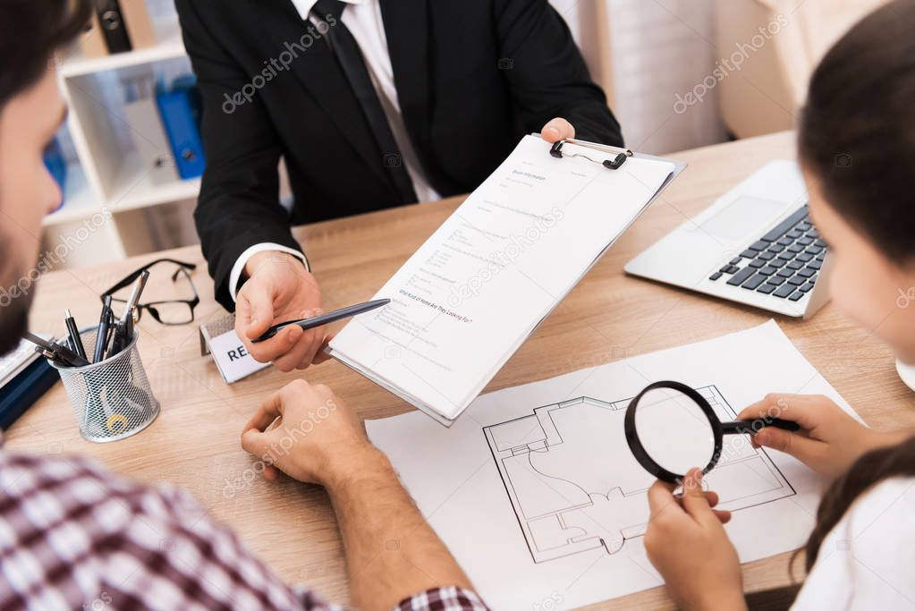 close up of man signing agreement, family buying new apartment in real estate agency