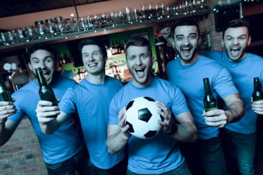 Futbol hayranları oyunu izlerken ve akşam spor barında bira içme Grup