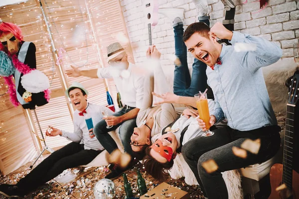 Gay jungs spielerisch posieren auf couch bei party. — Stockfoto