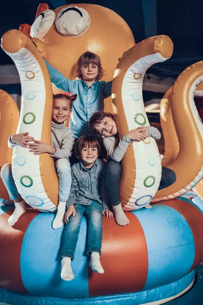 Cheerful children sitting on the attraction. — Stock Photo, Image