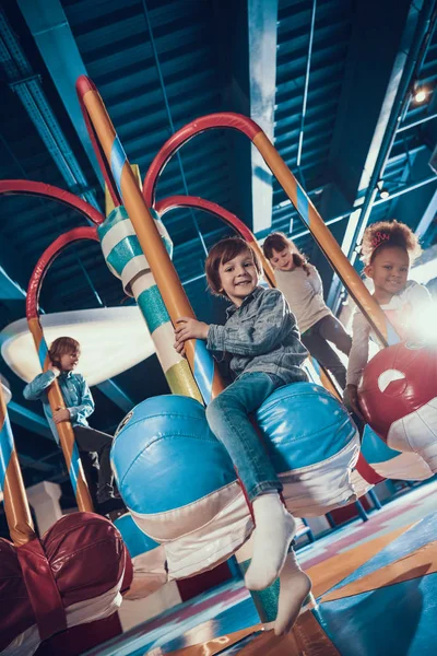 Children have fun while riding the attraction. — Stock Photo, Image