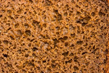 Eklenen çavdar malt ve kişniş closeup ile kahverengi çavdar ve buğday ekmek somun bölümünün arka plan