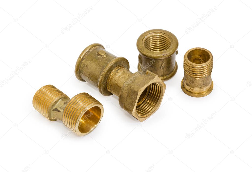 Brass eccentric connector, pipe couplings and other plumbing components on a white background