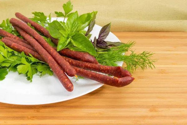 Fragment White Dish Long Thin Cured Smoked Sausages Greens Located — Stock Photo, Image