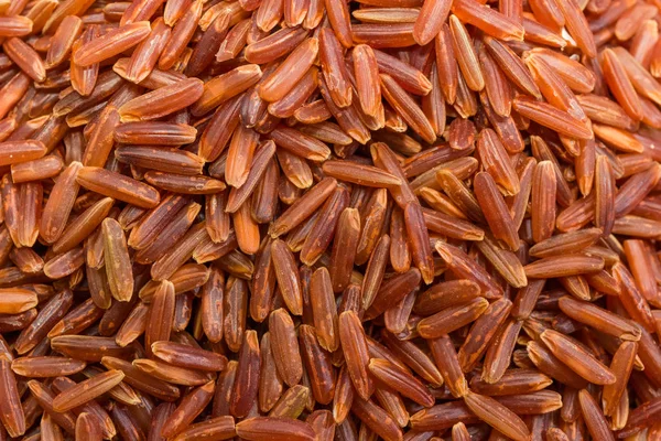 Background of the raw red rice close-up