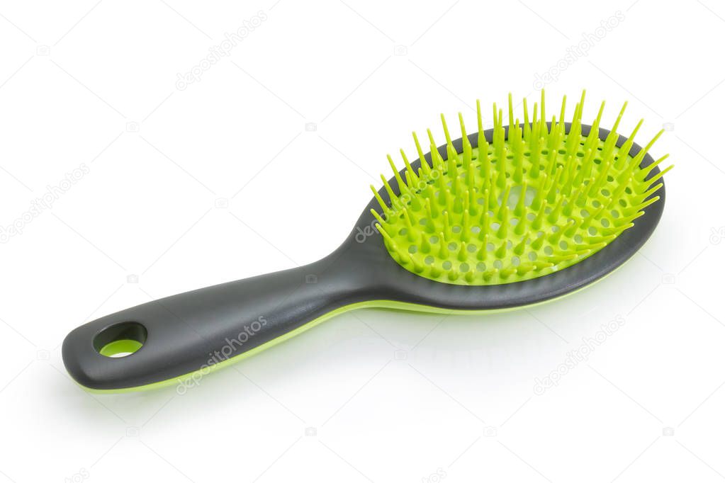 Gray and green hairbrush with plastic bristles on a white background
