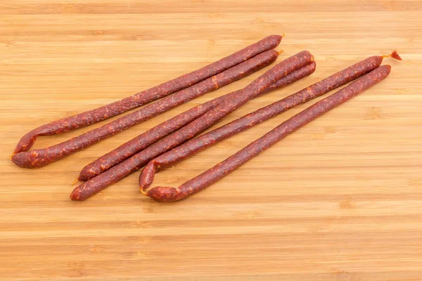 Several Long Thin Cured Smoked Sausages Edible Casing Close Bamboo — Stock Photo, Image