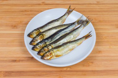 Baltık Ringa bir bambu ahşap yüzeyde beyaz daire füme