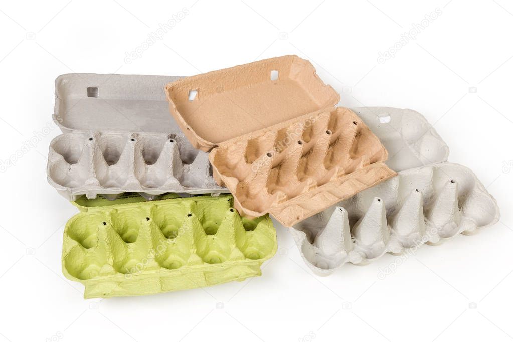 Different open empty egg cartons for ten eggs made of recyclable paper pulp on a white background