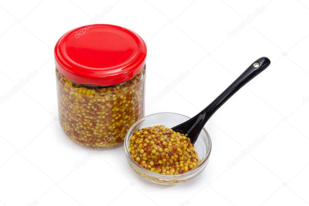 French mustard in glass jar and small  bowl with spoon