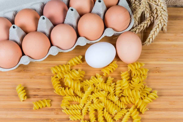 Uncooked spiral egg pasta different sizes and eggs