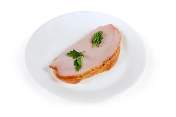 Open sandwich with cooked smoked pork with greens on dish — Stock Photo, Image