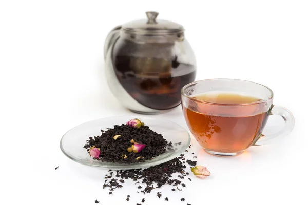 Tasse schwarzen Tee, Teeblätter mit Zusatzstoffen gegen Teekanne — Stockfoto
