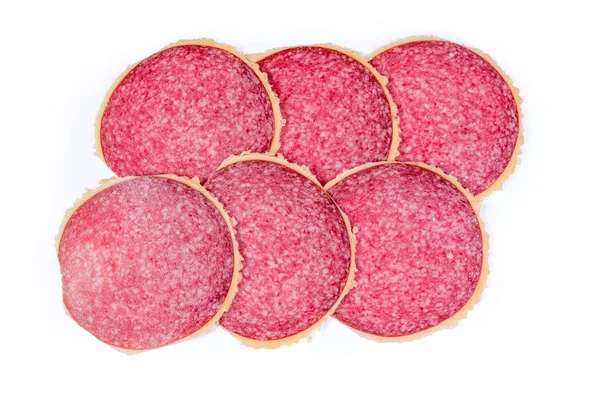 Fatias de salame revestido de parmesão em um fundo branco — Fotografia de Stock