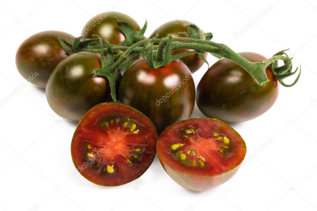 Cherry tomato kumato cut in half against of tomato cluster