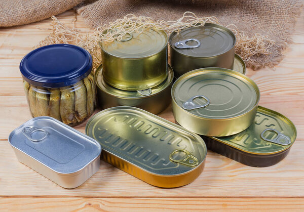 Canned fish in different sealed tin cans and glass jar