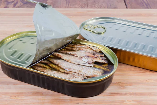 Sprats in partly open and sealed tin cans close-up — Stock Image Sprats in partly open and sealed tin cans close-up Royalty Free Stock Images
