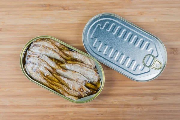 Top view of open and sealed tin cans of sprats — Stock Image Top view of open and sealed tin cans of sprats Royalty Free Stock Photos