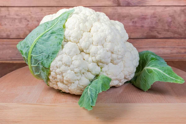 Fresh cauliflower head on the wooden surface — Stock Photo, Image