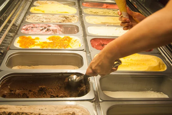 Refrigerated display case with different flavors of ice creams