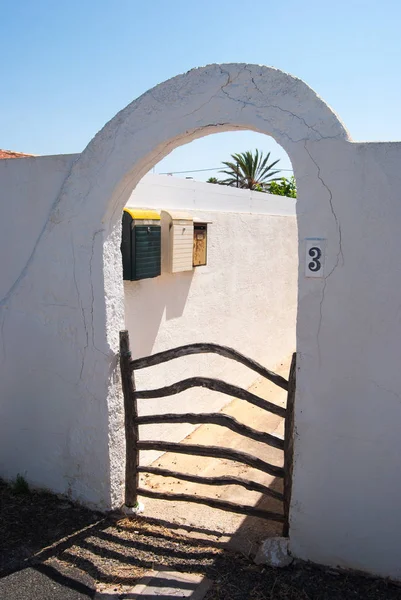 Characteristic entrance of typical white houses of Menorca with three mailboxes