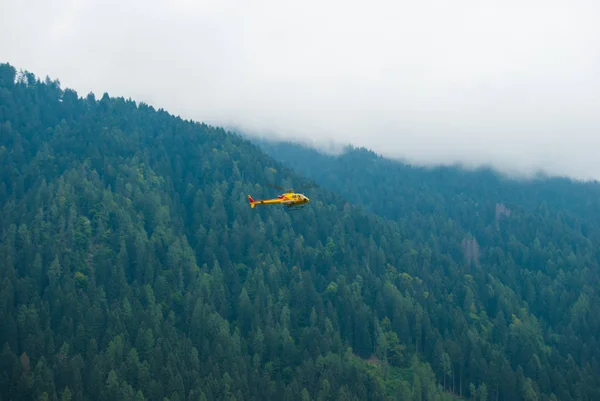 Bir görev sırasında sarı yardım helikopter uçuş