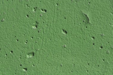 Fotoğraf üzerinde delikler ile yeşil renkte boyanmış eski beton duvar parçası güzel yatay doku