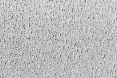 Gri ve beyaz renkte boyanmış ve fotoğrafta delikler olan eski beton duvarın bir kısmının güzel yatay dokusu