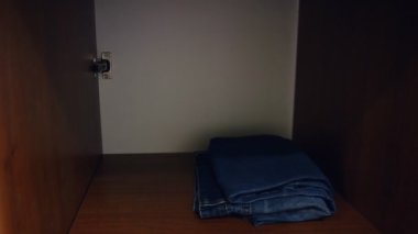 bir erkek giyim jeans bir raf dolap bir yakın çekim yapar.