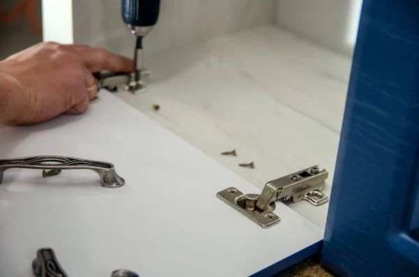 Installation of canopies on cabinet furniture with self-tapping screws using an electric screwdriver