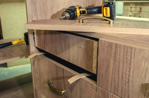 Installation of furniture handles on cabinet furniture