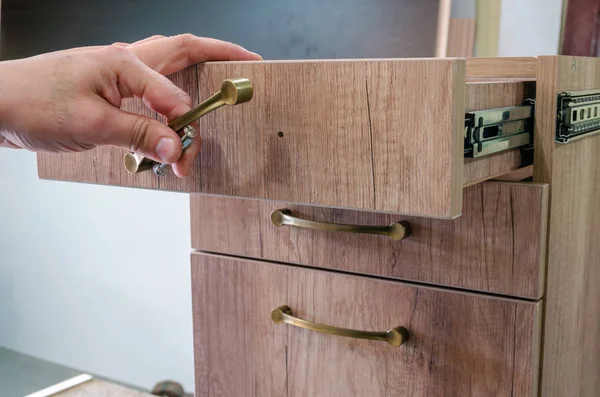 Assembling furniture, installing furniture decorative handles on the furniture facade — Stock Photo, Image