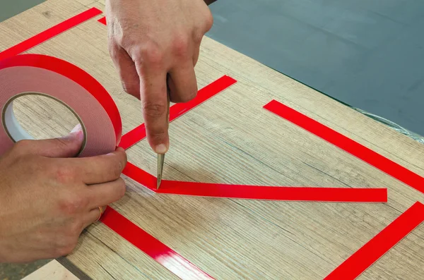 Double-sided tape, the master prepares the part for further sticking the mirror — Stock Photo, Image