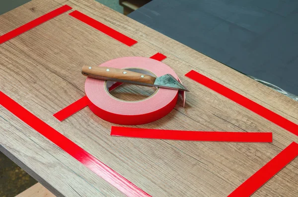 Double-sided tape, the master prepares the part for further sticking the mirror — Stock Photo, Image