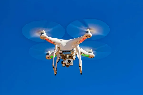 drone with camera flying with blue sky in the background