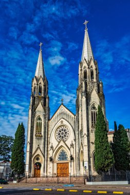 Cathedral church of Botucatu under blue sky with clouds at dawn clipart